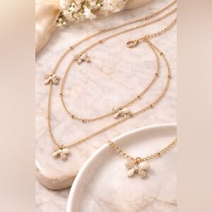 Two tiered delicate gold tone necklace w/enamel painted & pavé bows 🎀